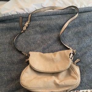 Beige shoulder bag with multiple pockets and compartments